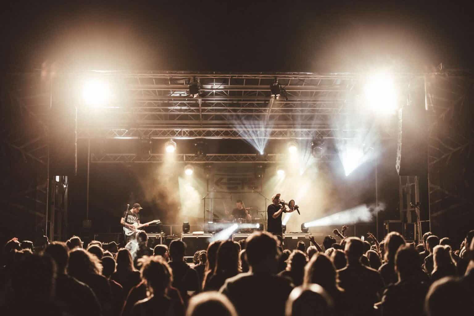 Live Musikperformance auf der Bühne mit Band und Publikum im Hintergrund. Woodlight, K-STE